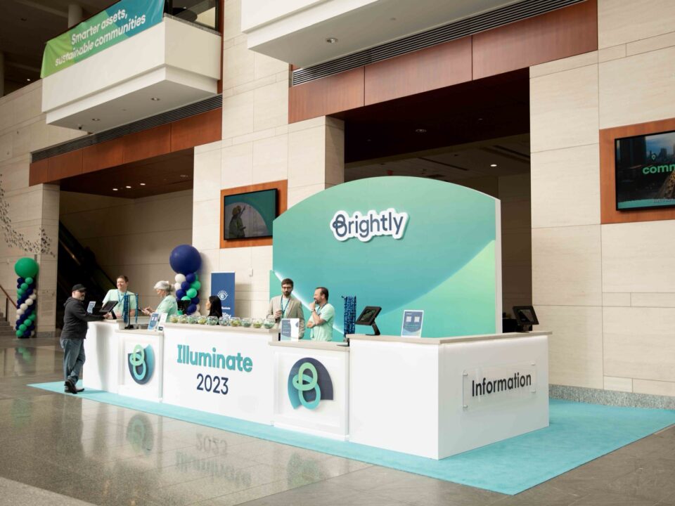 Representatives working at the Brightly booth at Illuminate 2023