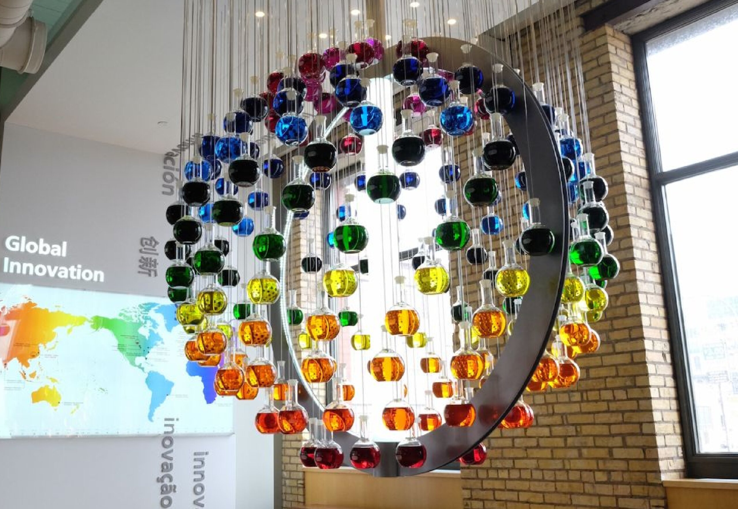 Colorful hanging ball display in front of a map