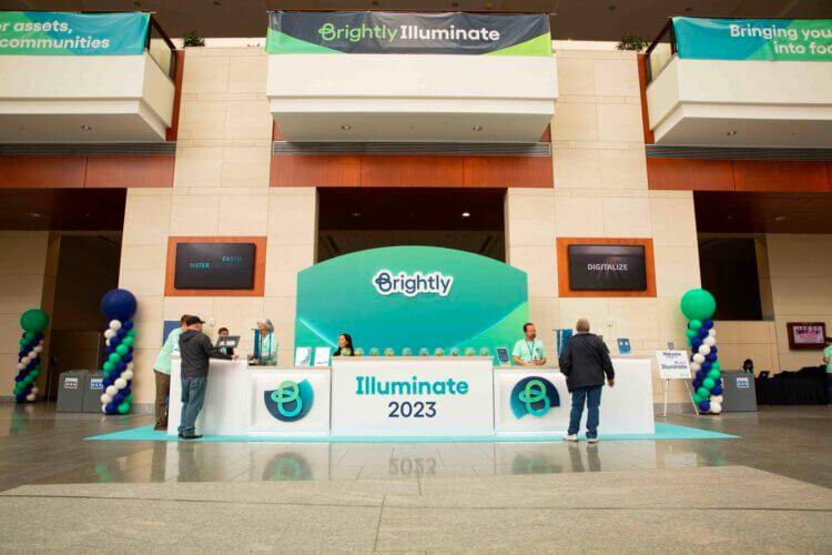 Brightly banners and desk at Illuminate 2023