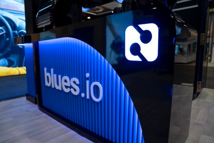 Illuminated Blues.io sign on their convention exhibit