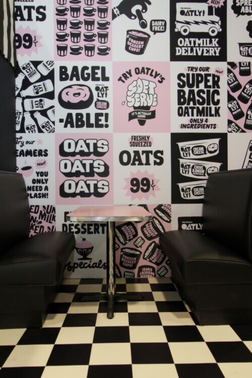 Oatly branded wallpaper and matching seating