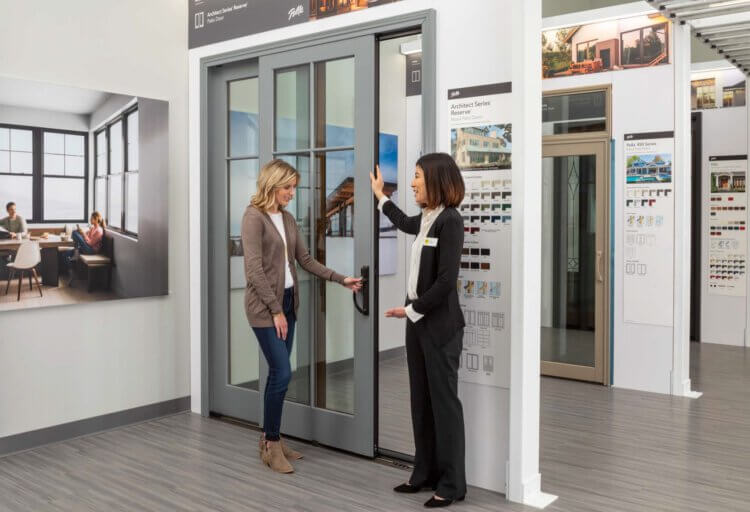 Representative speaking with a customer near a door display