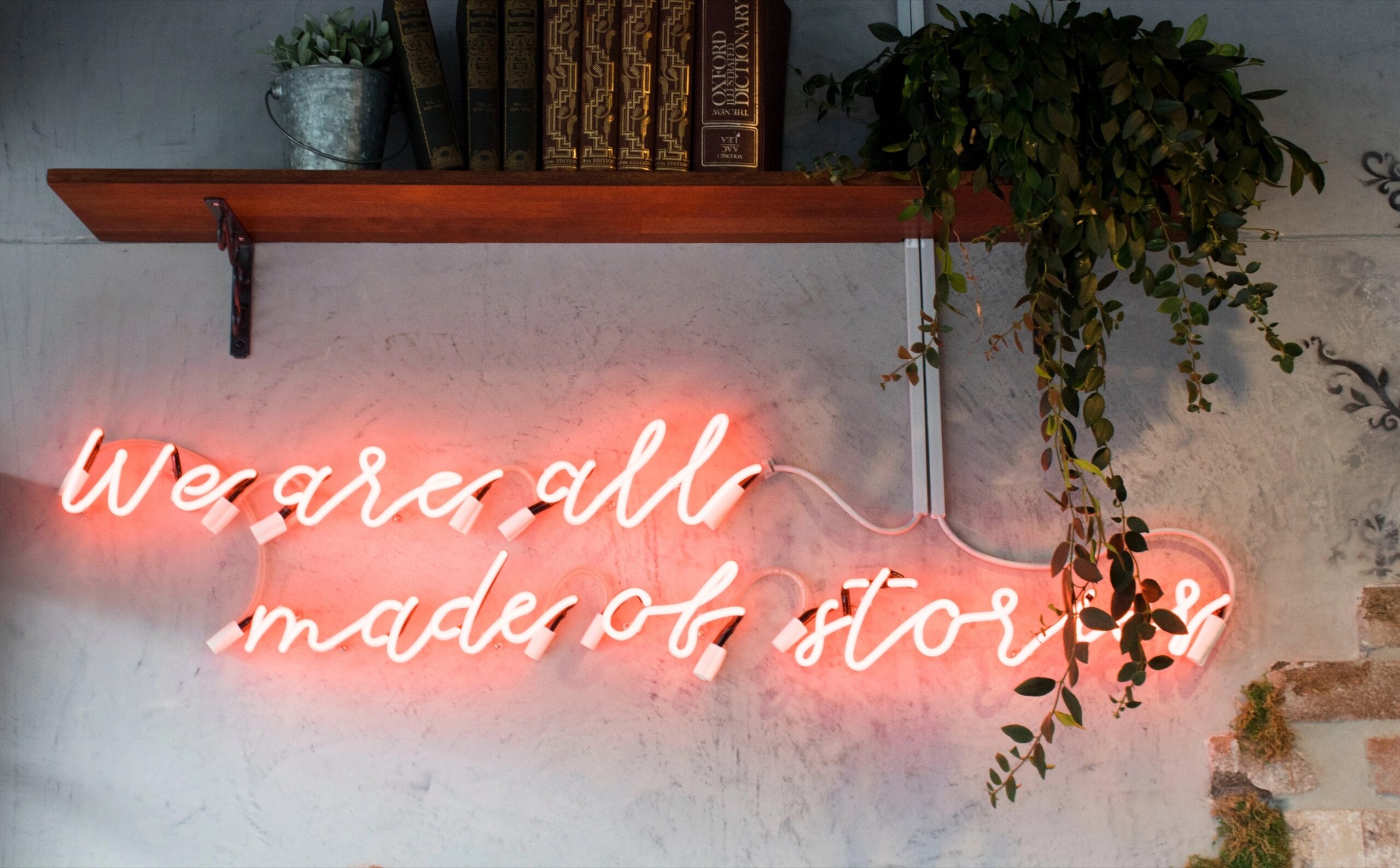 Neon sign that reads, "We are all made of stories"