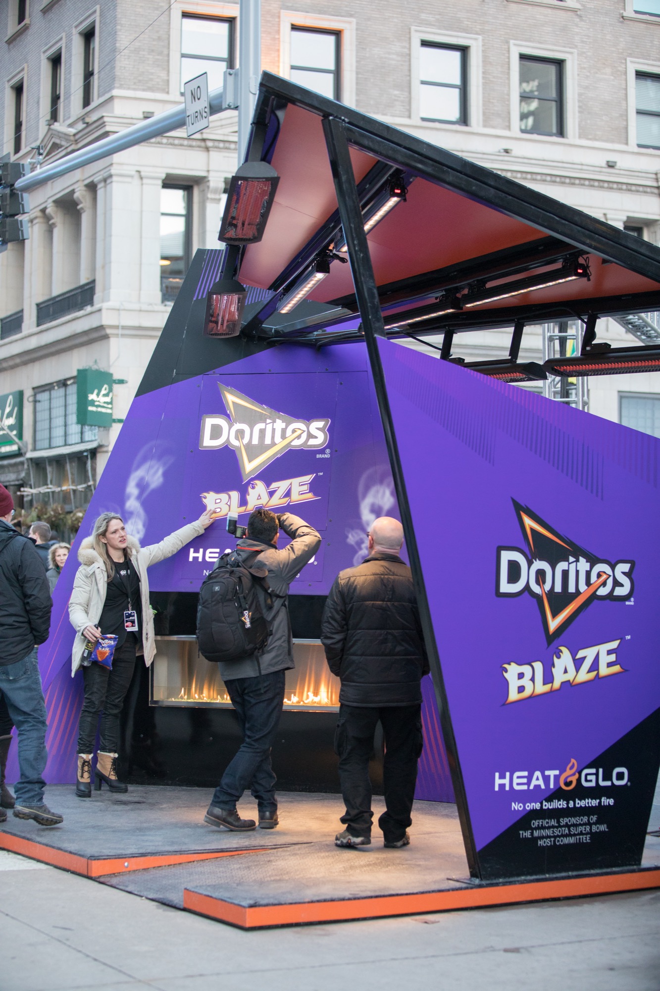 People gathering around a Doritos and Heat & Glo advertising stunt for warmth