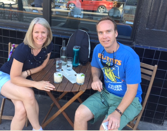 Gary and his wife sitting at a table outdoors together