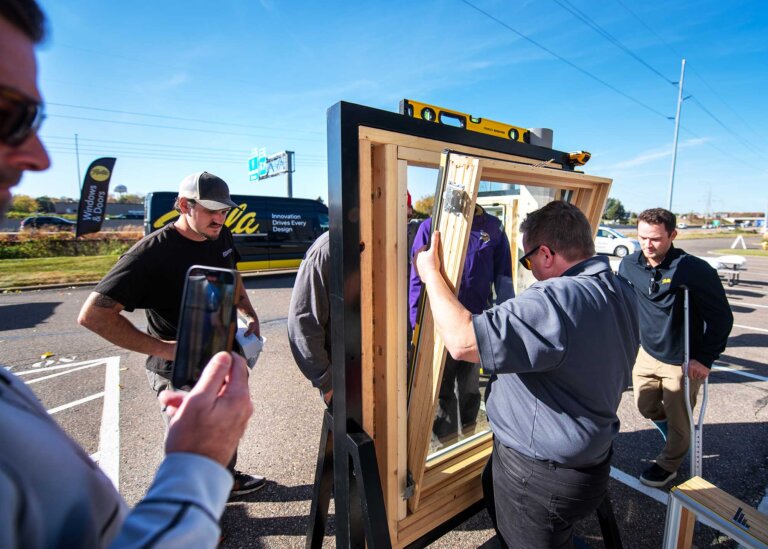 Team participating in window demo as part of a traveling trade show demonstration.