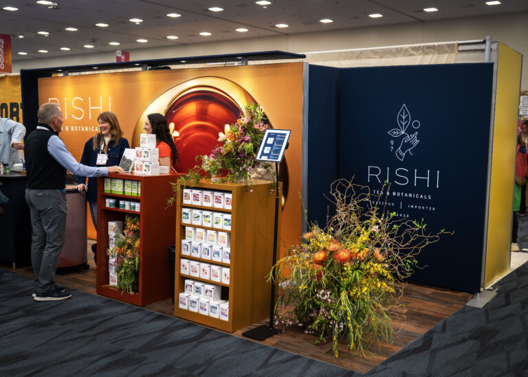 An image of the Rishi Tea 10x10 trade show display at Expo West 2025 featuring how they displayed their products and sampling in their exhibit space.