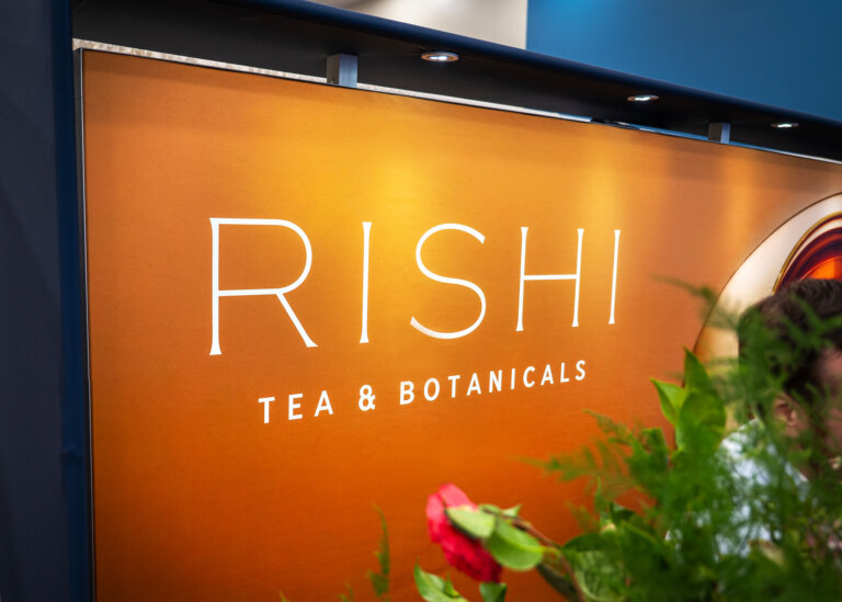 An image of the Rishi Tea 10x10 trade show display at Expo West 2025 featuring how they displayed their logo in their exhibit space.