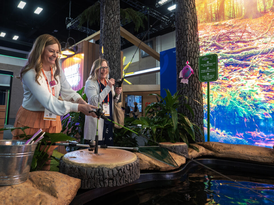 Image of an activation from ExhibitorLive, that features a fishing pool and fake fish