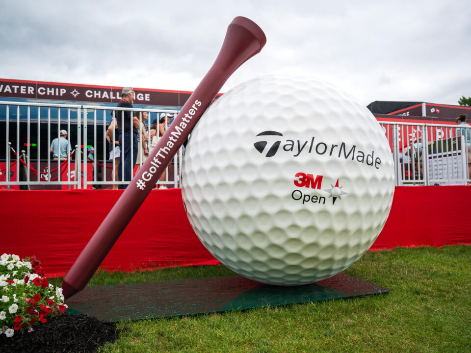 Image of a statue of a large golf ball and tee with the hashtag #golfthatmatters on them as well as the TaylorMade logo and the logo for the 3M Open.
